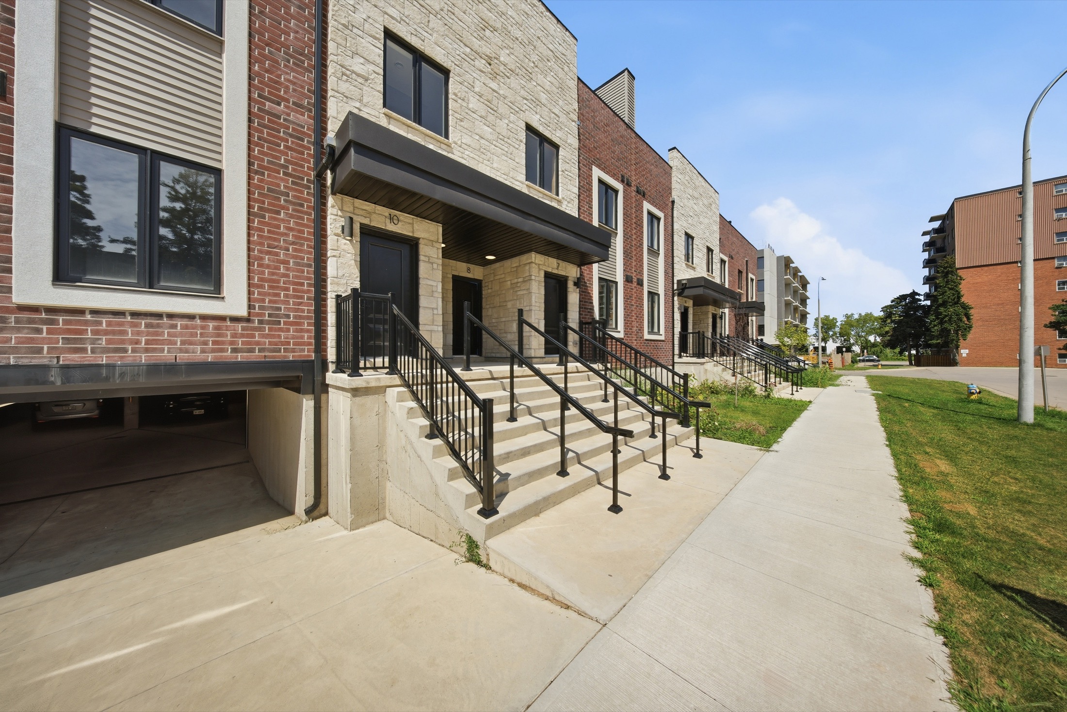 Street-level view of the Sky Terraces townhome entrances at 2 Slessor Boulevard