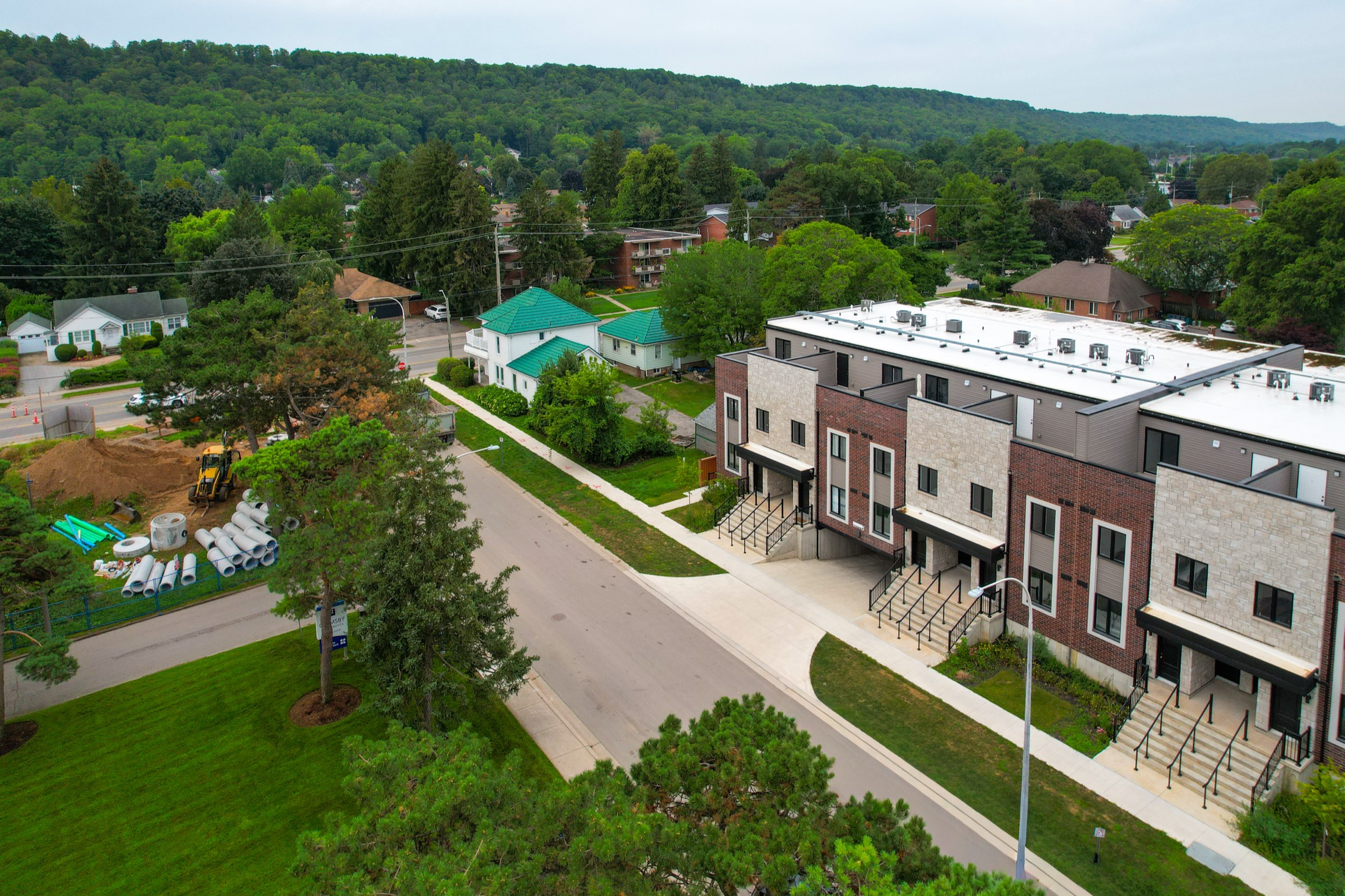 Sky Terraces townhomes with the wooded Niagara Escarpment rising behind