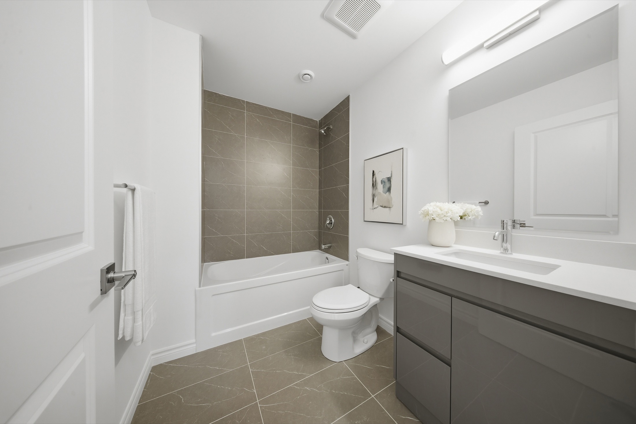 Bathroom with large-format porcelain tile and quartz vanity